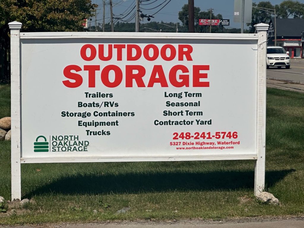 North Oakland Storage outdoor storage sign in Waterford, MI, offering trailer, boat, RV, equipment, and truck storage.